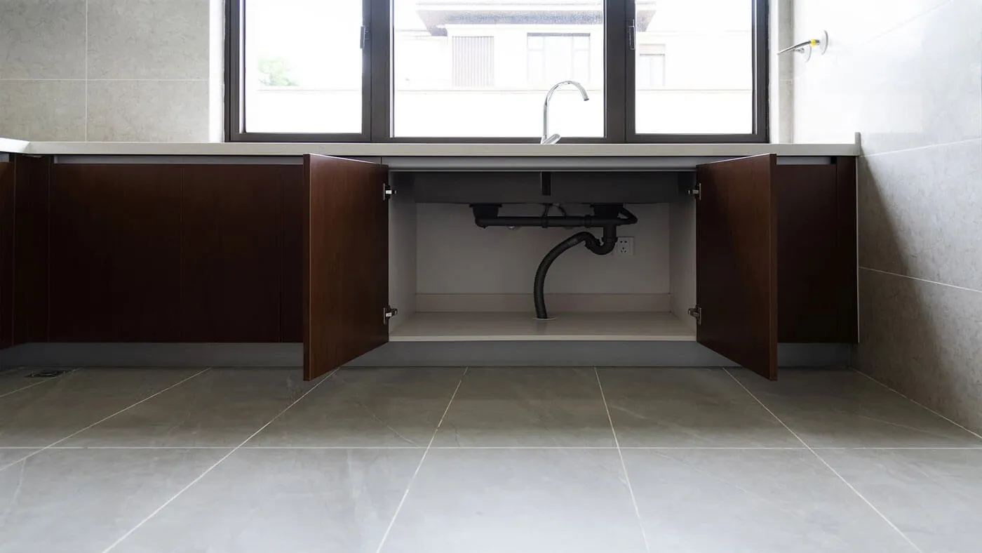 The same sink cabinet with the pipework repaired and dry
